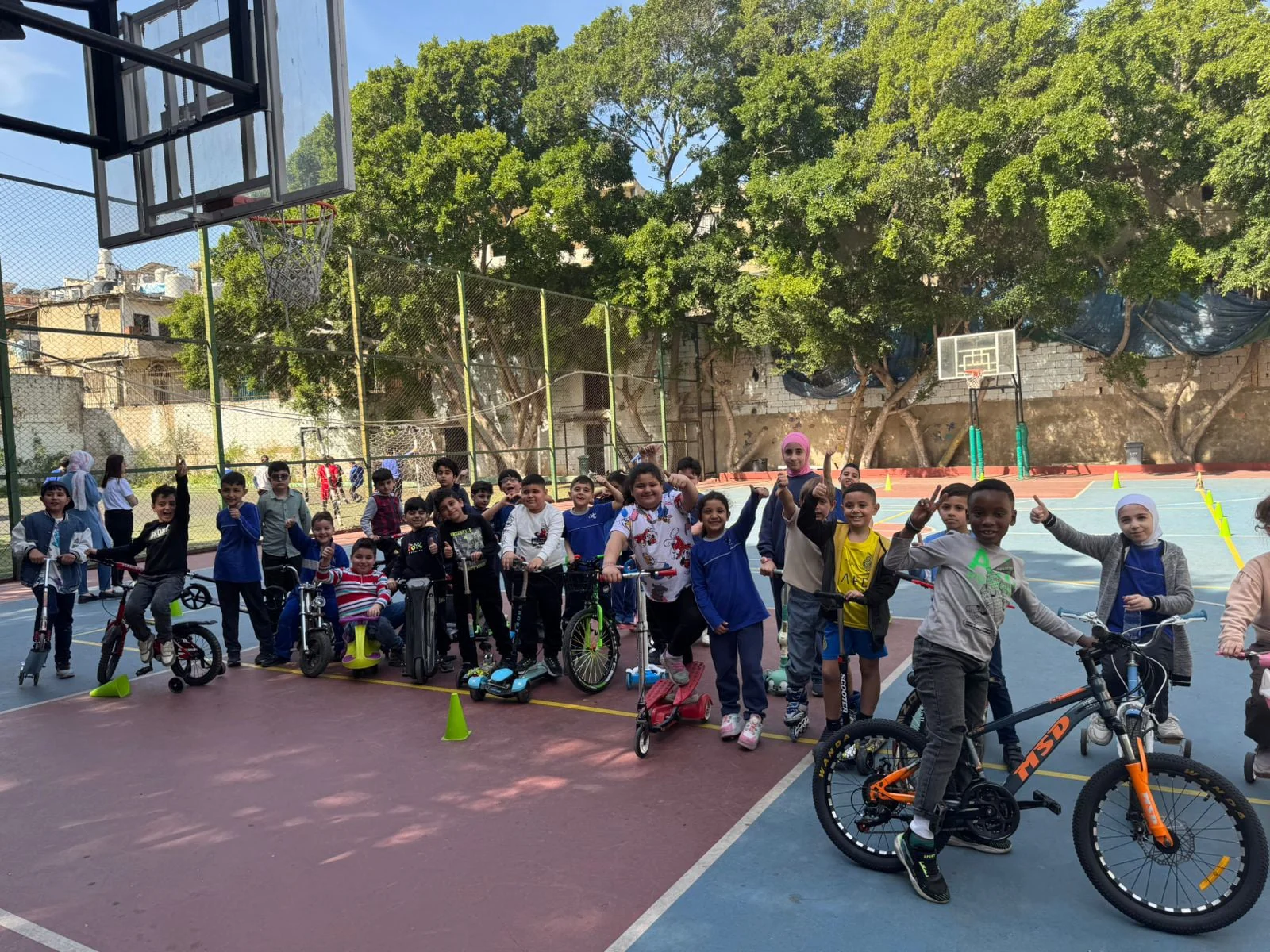 Heritage College students gathered with bicycles and scooters on the school sports court