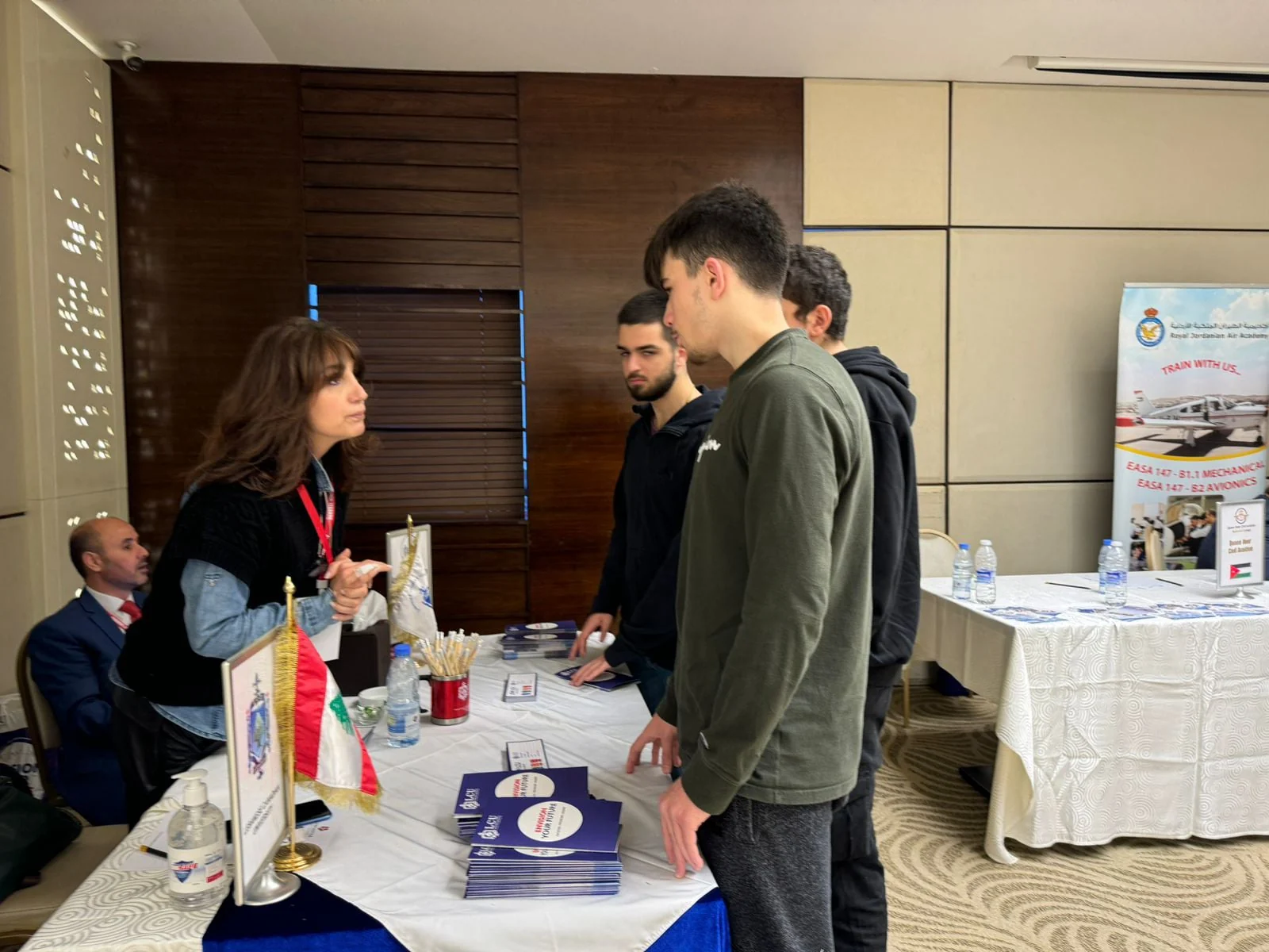 Students talking to a representative at a university information stand
