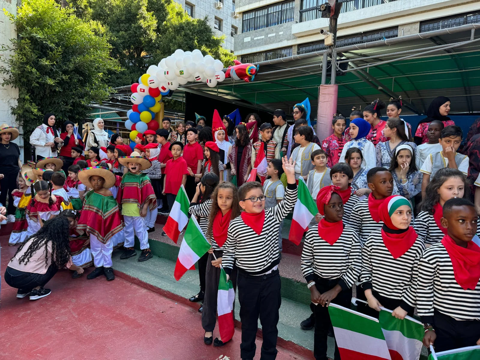Students celebrating Culture Day outdoors with Lebanese flags
