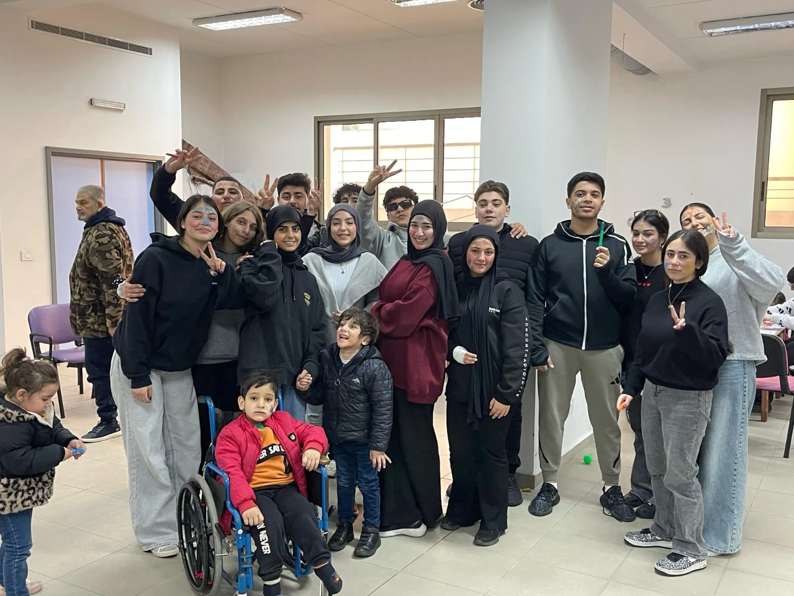 Heritage College students and community members posing together indoors
